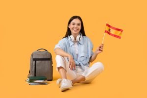 Happy woman with Spanish flag on yellow background