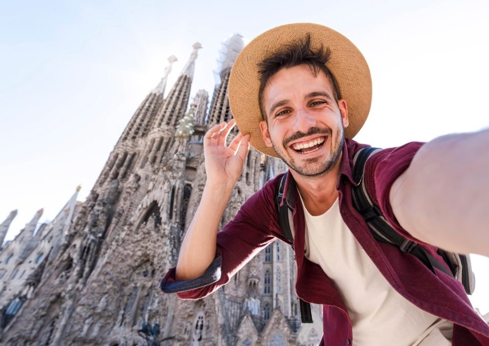 Happy tourist visiting La Sagrada Familia, Barcelona Spain